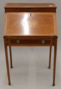 An Edwardian inlaid mahogany bonheur du jour. 61 cm wide.