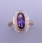 An Art Deco style 9 ct gold amethyst and diamond ring with engraved shoulders. Ring size L. 4.