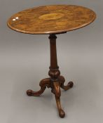 A Victorian inlaid walnut tripod table. 60 cm wide.