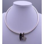 An abstract design silver and cut amethyst choker and pendant, hallmarked London.