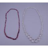 A single row of faceted rock crystal beads and a string of faceted rubellite beads.