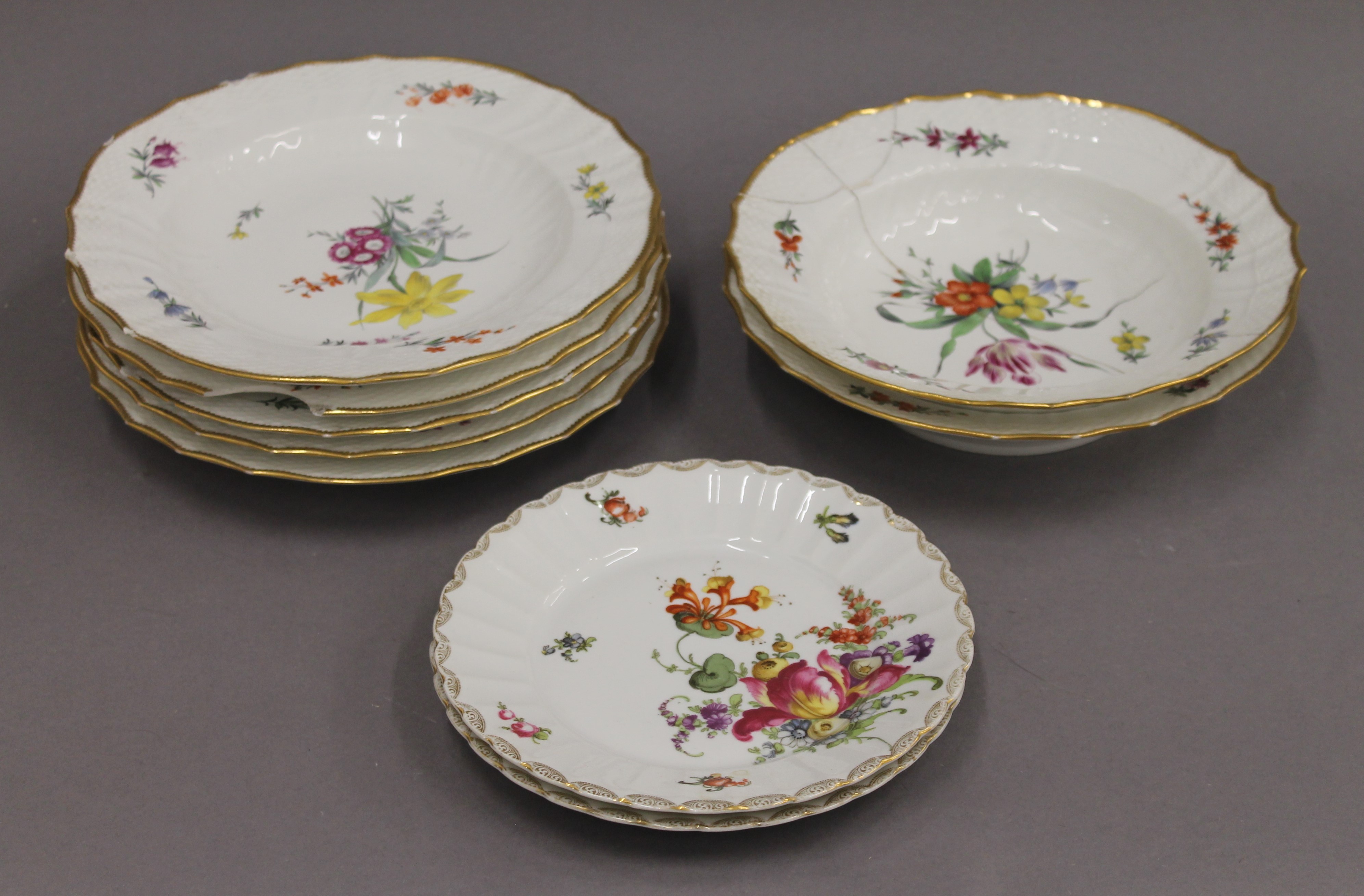 A quantity of Copenhagen porcelain florally decorated plates and dishes.