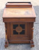 A Victorian walnut davenport. 61 cm wide.