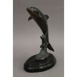 A patinated brass model of a dolphin. 21 cm high.