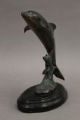 A patinated brass model of a dolphin. 21 cm high.