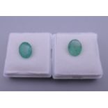 Two loose emeralds. Each approximately 9 mm long.