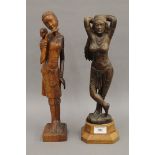 Two Eastern carved wooden figures. The largest 37.5 cm high.