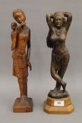 Two Eastern carved wooden figures. The largest 37.5 cm high.