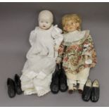 Two dolls and a collection of vintage child's shoes.