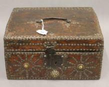 A 17th/18th century decorative studded leather clad domed box. 30.5 cm wide.