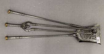 A set of Georgian brass mounted steel fire irons. The shovel 63 cm long.