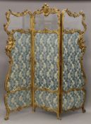 A 19th century three-fold gilt framed glazed and tapestry inset screen.