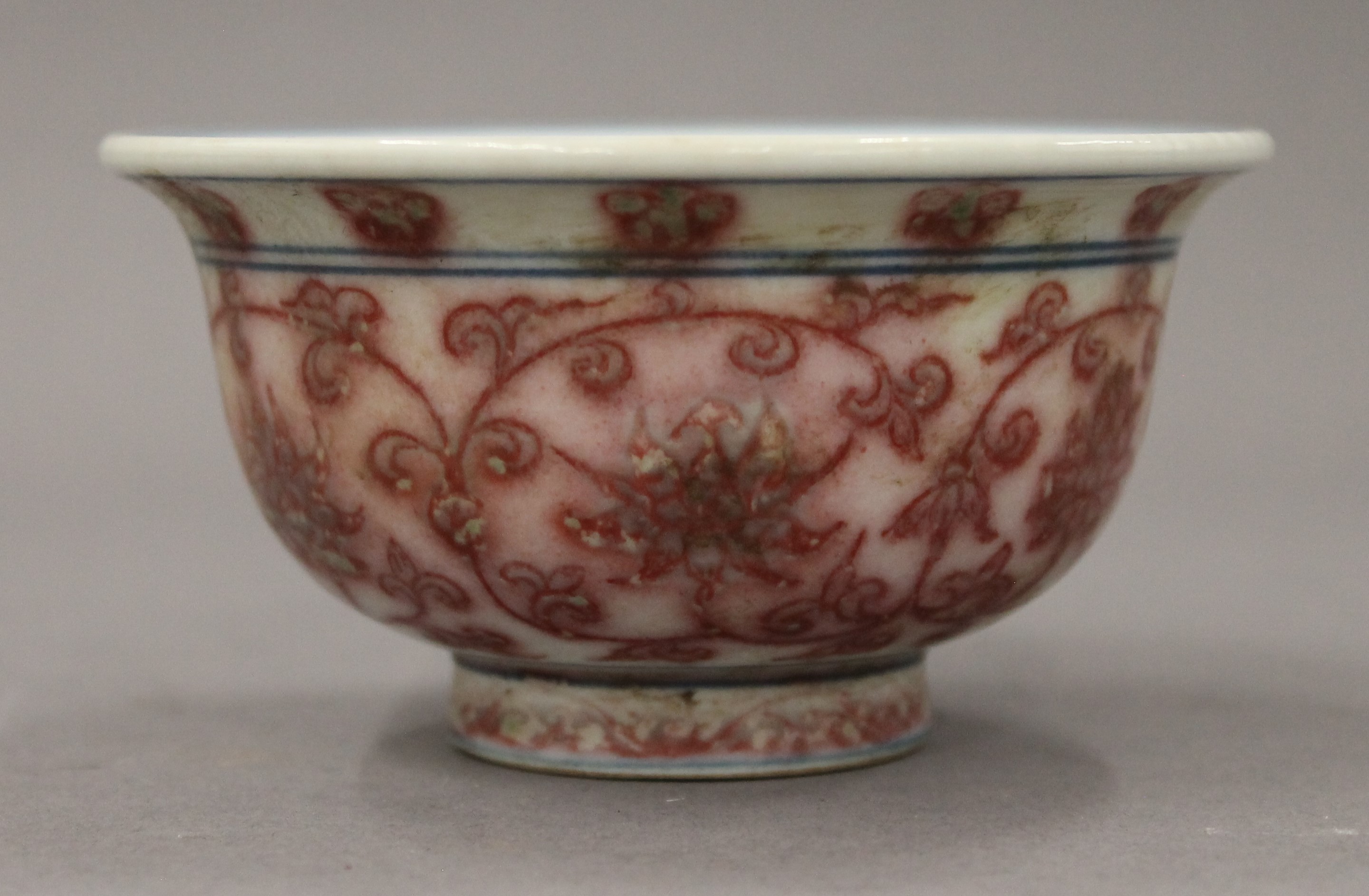 A Chinese porcelain tea bowl with red floral decoration. 9.5 cm diameter.