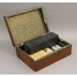 A wooden box containing a collection of various coins