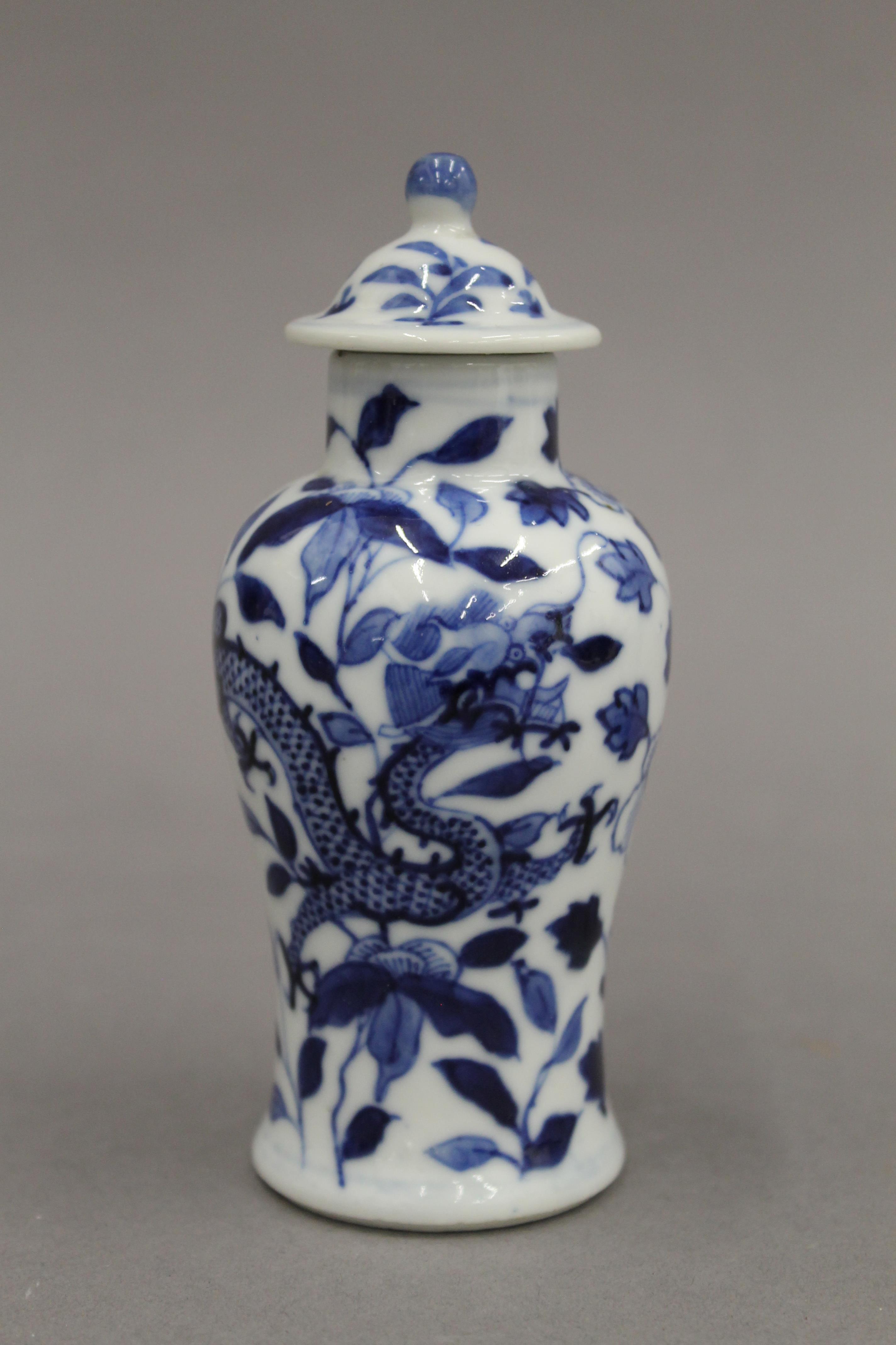 A pair of 19th century Chinese blue and white porcelain vases and covers, decorated with dragons. - Image 2 of 16