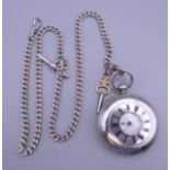 A silver half hunter key wind pocket watch, with silver Albert chain. 4.6 cm diameter.