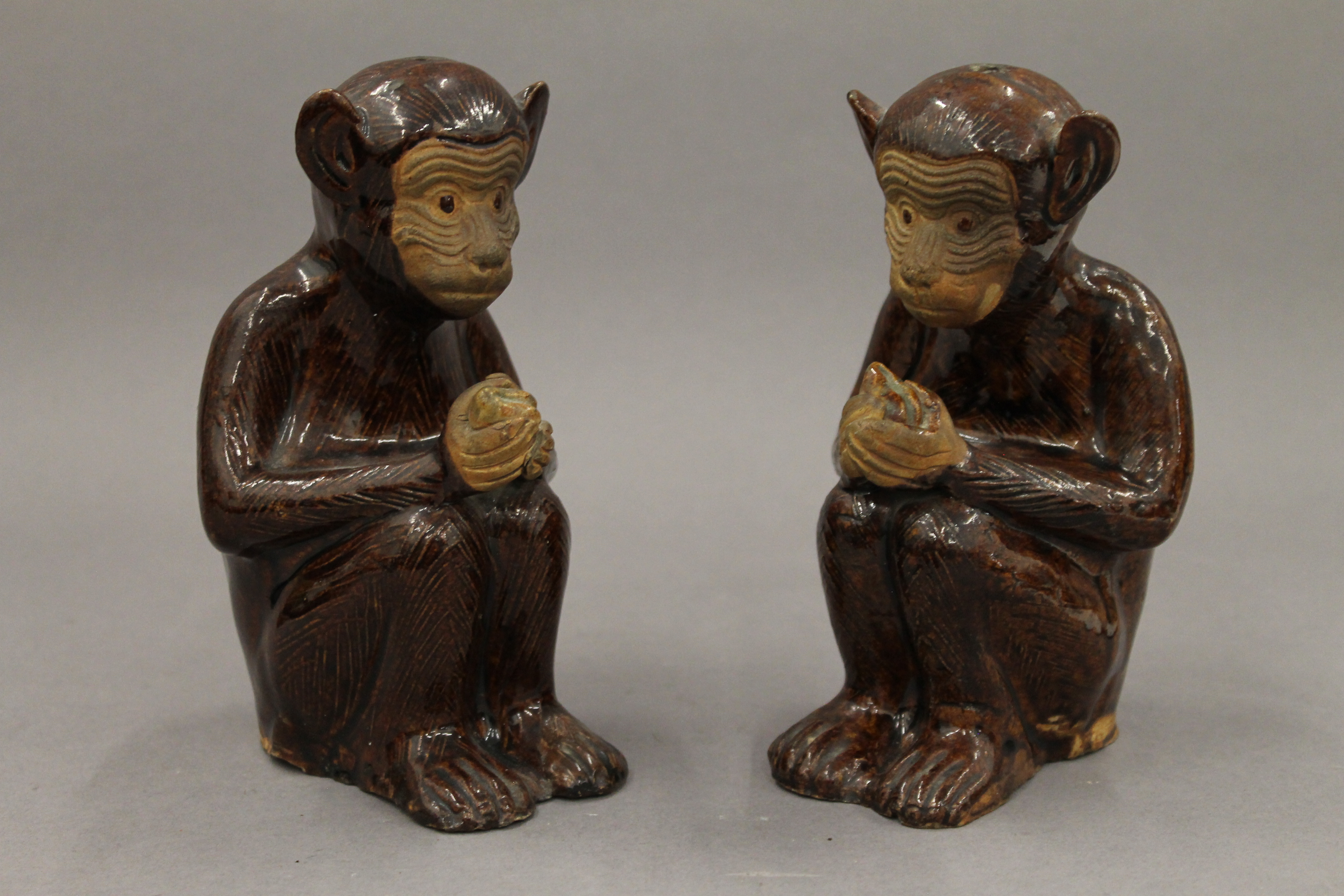 A pair of pottery censers formed as monkeys. Each 15 cm high.
