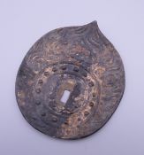An iron, possibly tsuba. 8.5 cm wide.