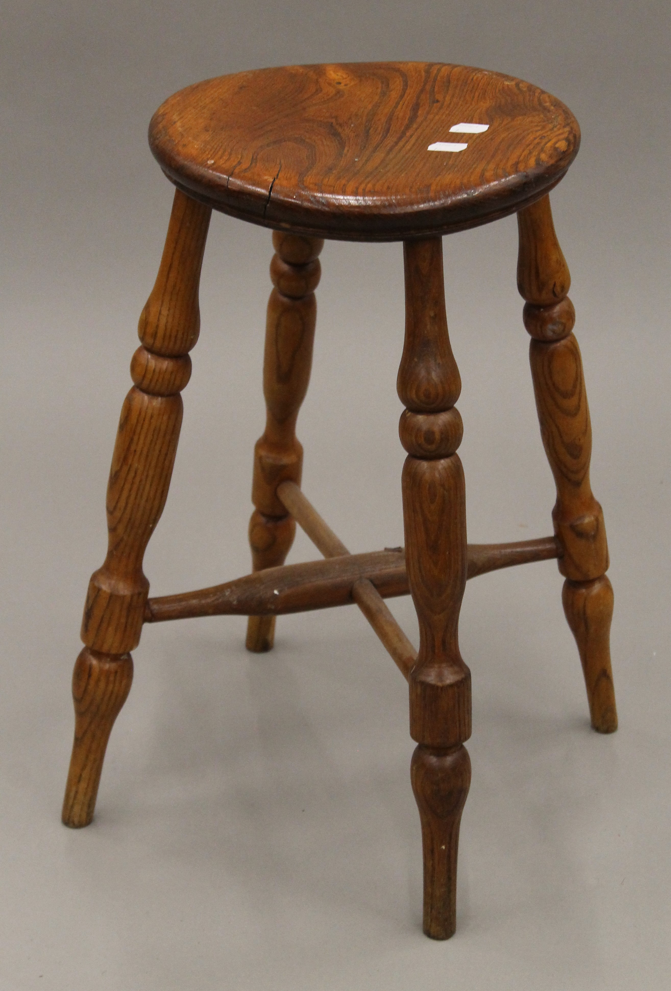 An elm stool. 52 cm high.