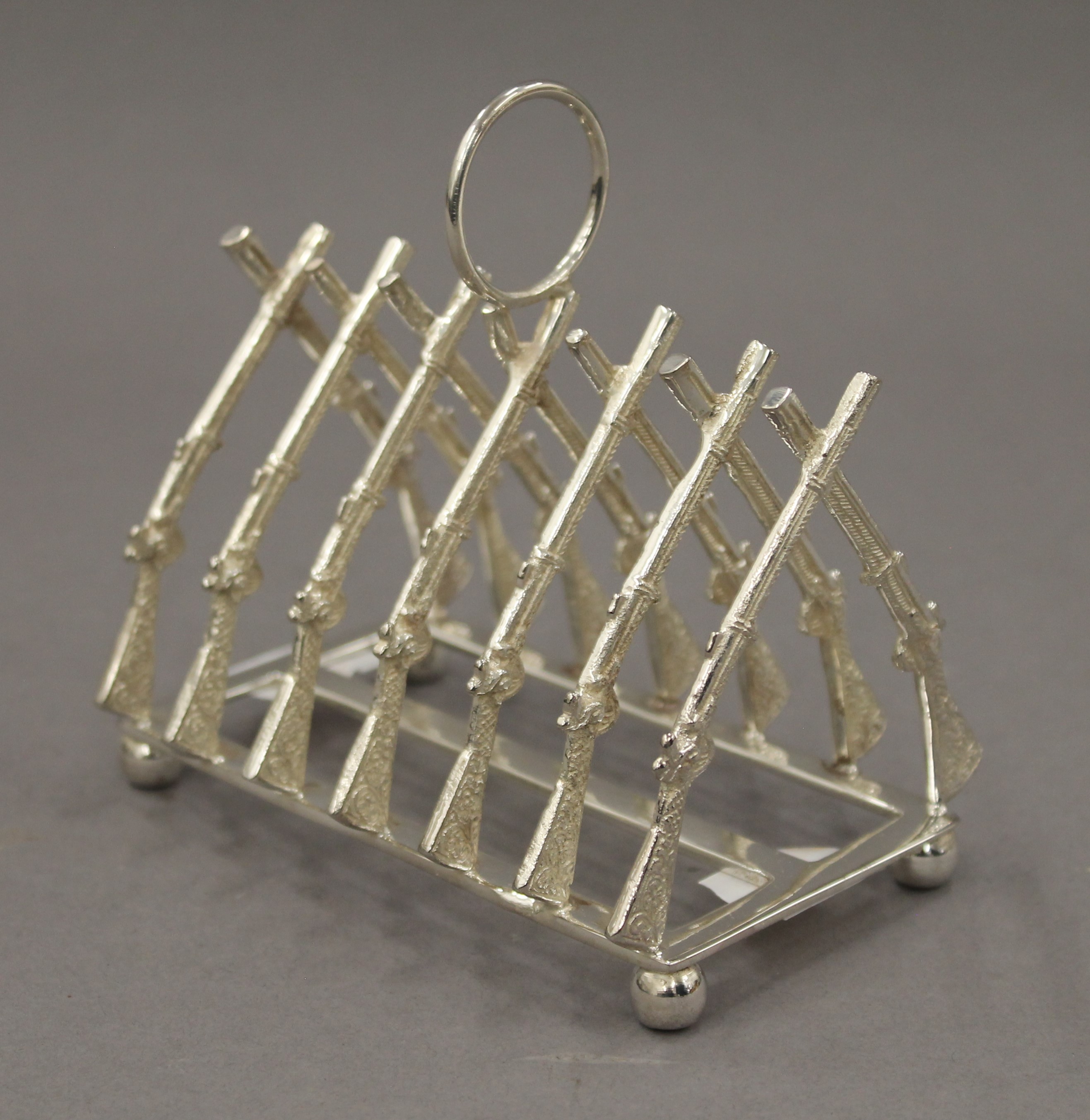 A rifle formed toast rack. 11.5 cm long.