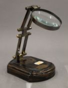 A brass desk magnifier. 9.5 cm wide.