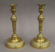 A pair of Victorian brass candlesticks. 27 cm high.