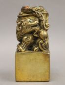 A Chinese bronze fo dog seal set with coral and turquoise cabochons. 12 cm high.