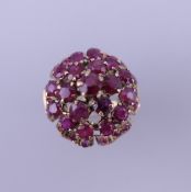 A 14 ct gold ruby cocktail ring. Ring size K/L. 5.7 grammes total weight.