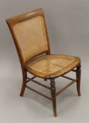 A Victorian caned nursing chairs. 44 cm wide.