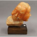 An unusual carved pink alabaster double bust sculpture mounted on a wooden plinth base. 28.
