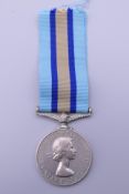 A British Military Elizabeth II Royal Observer Corps medal awarded to Observer G H Dovell.