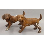 A pair of cast iron models of dogs. Each 23 cm high.
