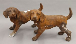 A pair of cast iron models of dogs. Each 23 cm high.