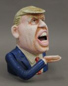 A Donald Trump cast iron money box. 15 cm high.