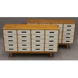 A pair of mid-20th century white painted banks of school drawers. Each 120 cm wide.