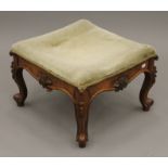 A Victorian upholstered walnut stool. 51.5 cm wide.