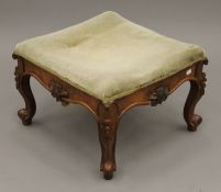 A Victorian upholstered walnut stool. 51.5 cm wide.