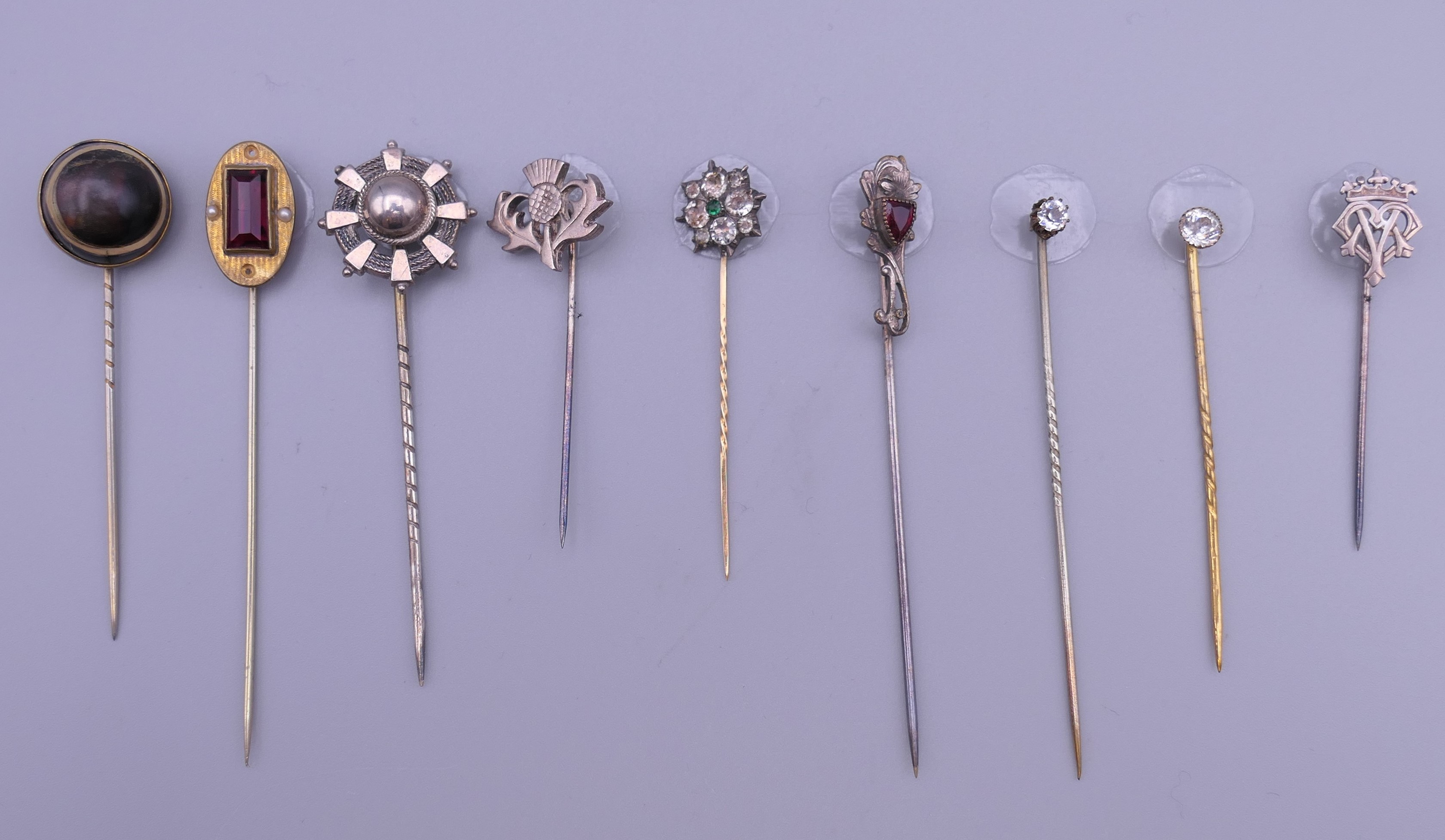 A quantity of antique stickpins. The largest 7.5 cm high.