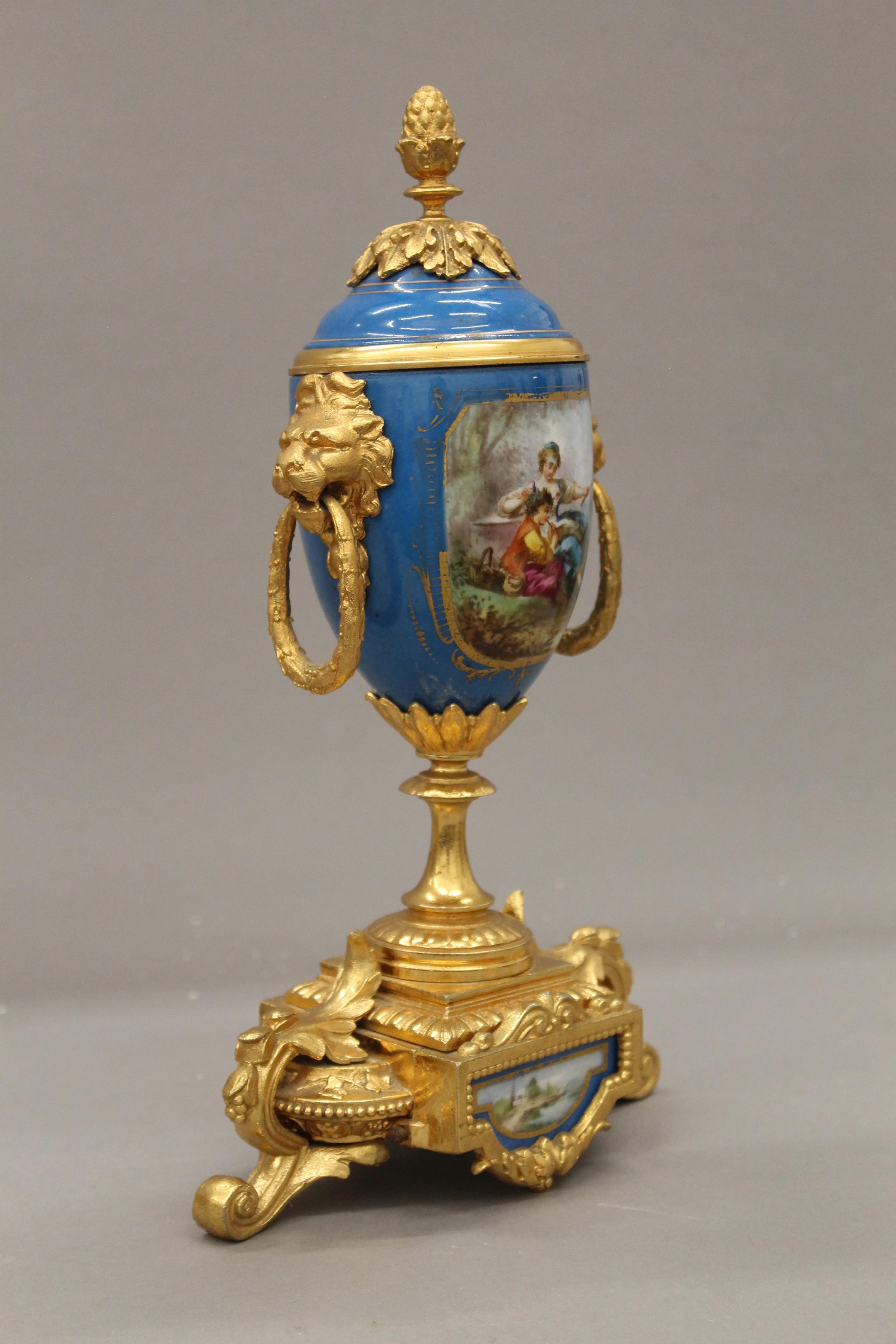 A 19th century gilt and painted porcelain three-piece clock garniture. The clock 37 cm high. - Image 9 of 11