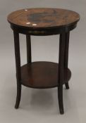 A 19th century mahogany two-tier side table. 52 cm diameter.