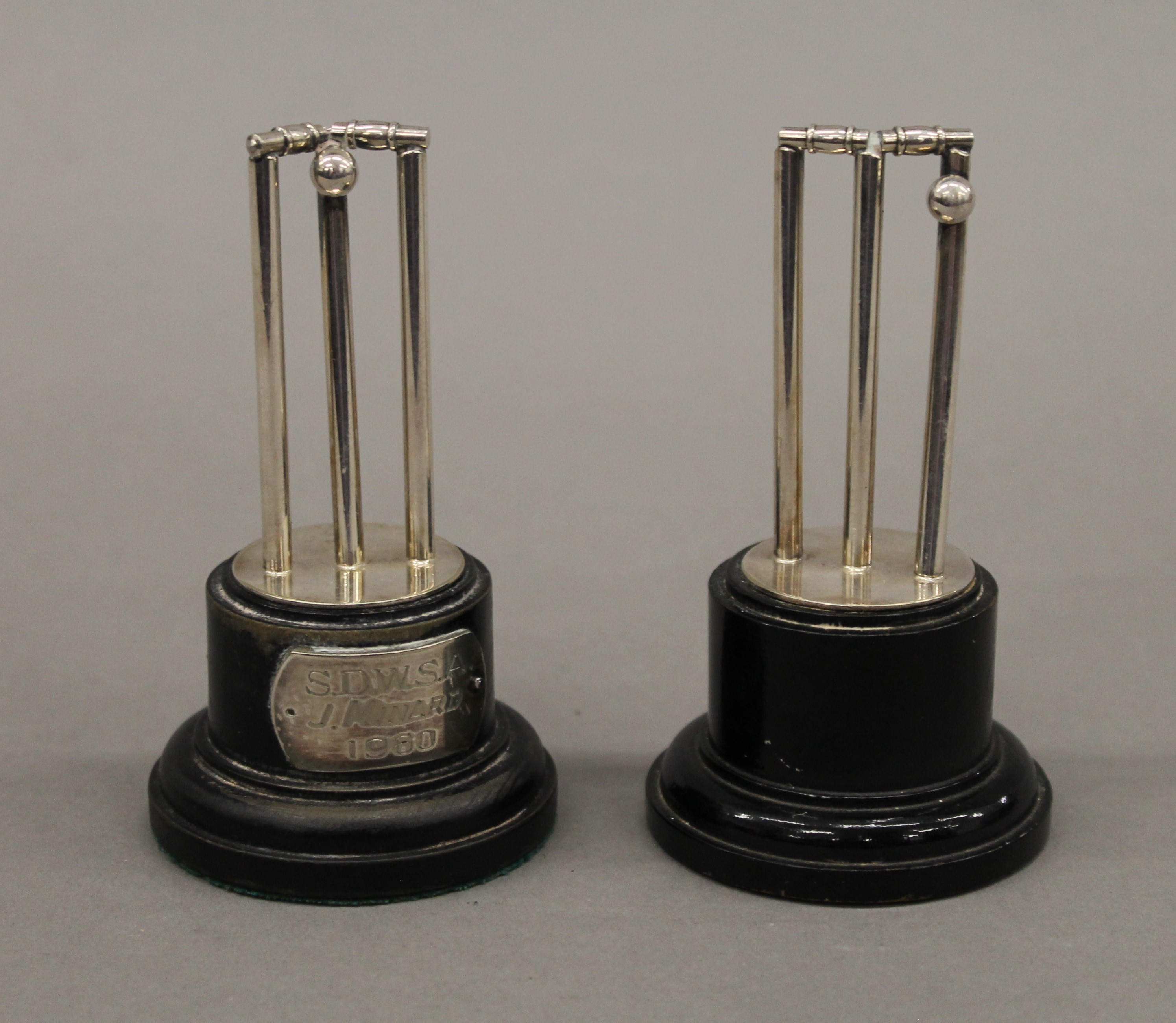 A pair of silver plated cricket trophies. Each 9 cm high.