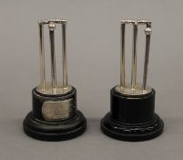 A pair of silver plated cricket trophies. Each 9 cm high.
