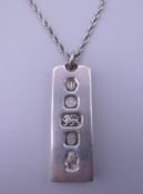 A silver ingot on chain. 36.6 grammes.