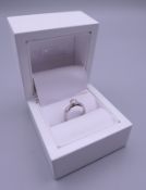 A 14 ct white gold diamond solitaire ring, the stone spreading to just under 0.5 carat.