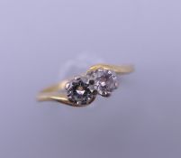 An 18 ct gold two stone diamond cross over ring. Each stone spreading to approximately 0.25 carat.