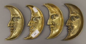 Four late 19th/early 20th century brass half moon dishes. Each approximately 15 cm high.