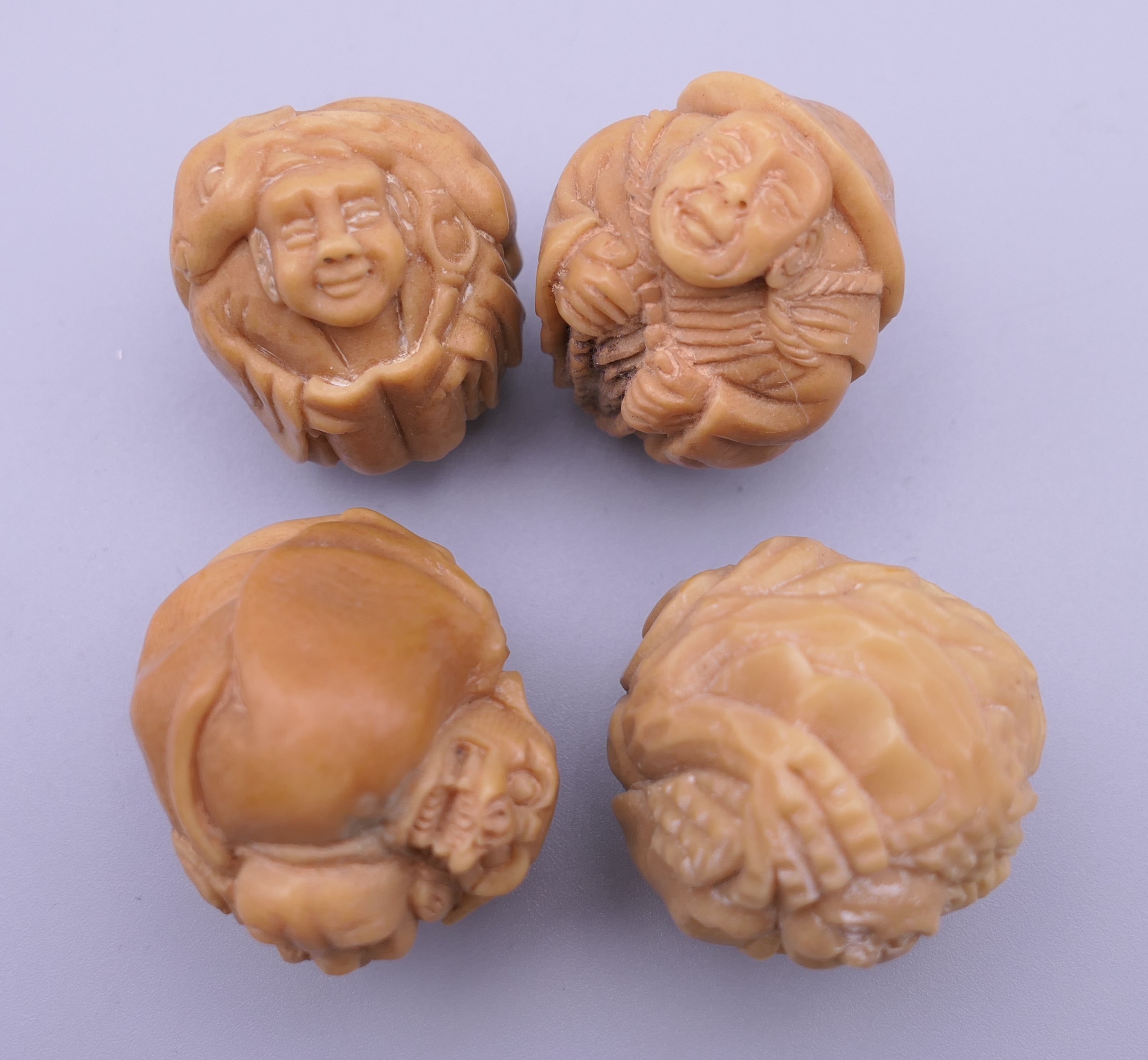 Four carved bone netsuke. Each approximately 3 cm wide. - Image 2 of 4