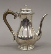 A silver coffee pot. 19.5 cm high. 21.1 troy ounces total weight.