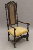 An 18th century caned back open armchair. 58 cm wide.