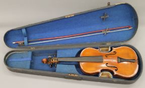 A 19th century half size violin, with bow and case. 56 cm long.